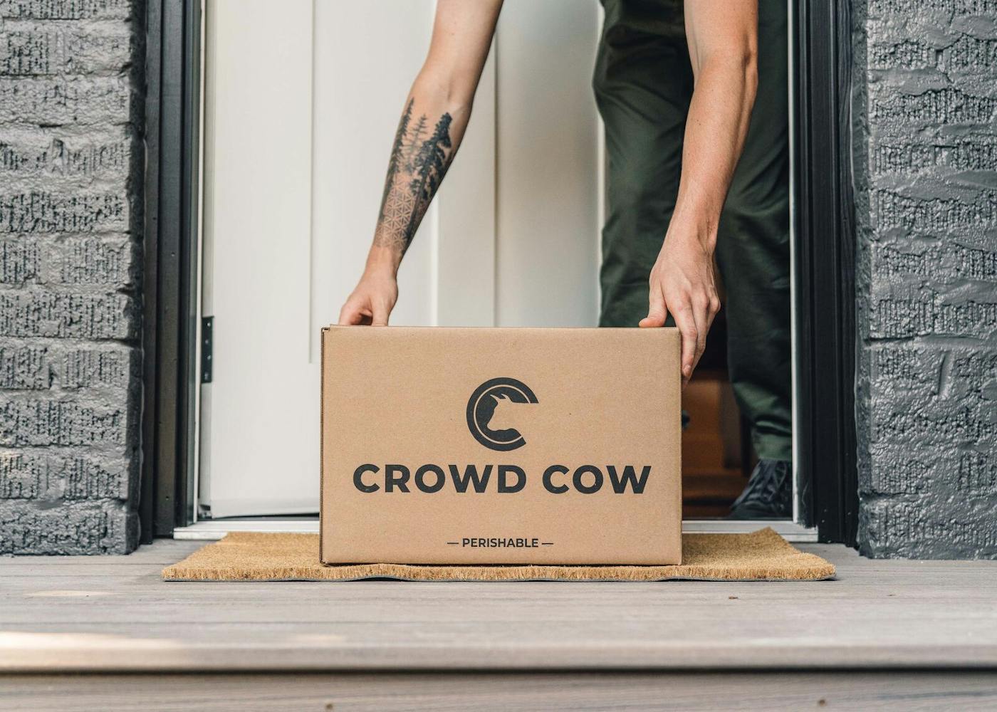 Crowd Cow box being picked up off the front porch
